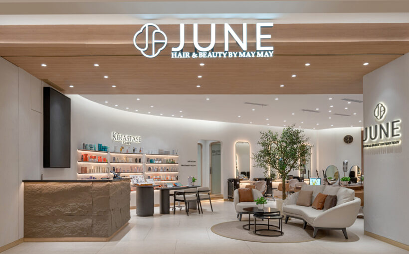 Entrance view of June by May May salon in Grand Indonesia, showcasing the logo, modern furniture, and natural earth tones for a sophisticated, welcoming atmosphere.